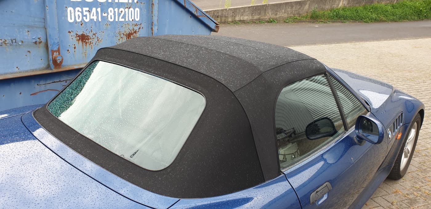 BMW Cabrio blau neues schwarzes Verdeck im Regen